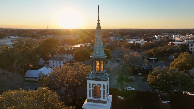 A Scenic View of Ocala, Florida, with The Sun Setting Behind the Town's Historic Church Steeple