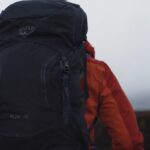 A Person with A Backpack Walking, Ideal for Carrying Easy-To-Pack Games on A Backpacking Trip