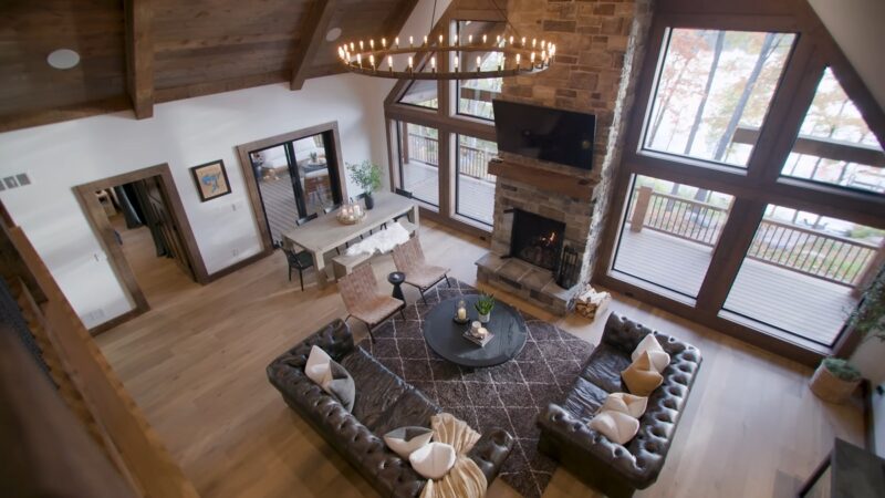 A high-angle view of a warm and inviting cabin living area with a stone fireplace