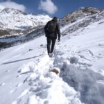 A Solo Traveler Trekking Through Snowy Terrain, Perfect for Solo Backpacking Adventures in The Mountains