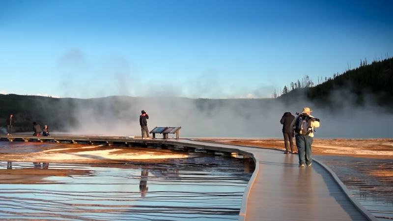 Visitors Walk Along a Boardwalk in Yellowstone National Par